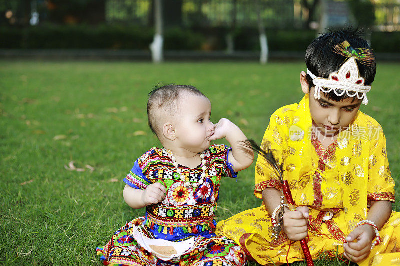 在shri krishna janmashtami节日期间，兄弟姐妹一起坐在户外的肖像画上